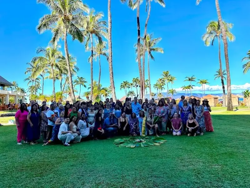 A group of people standing in the grass.