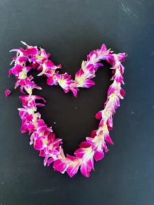 A heart shaped lei is displayed on the table.