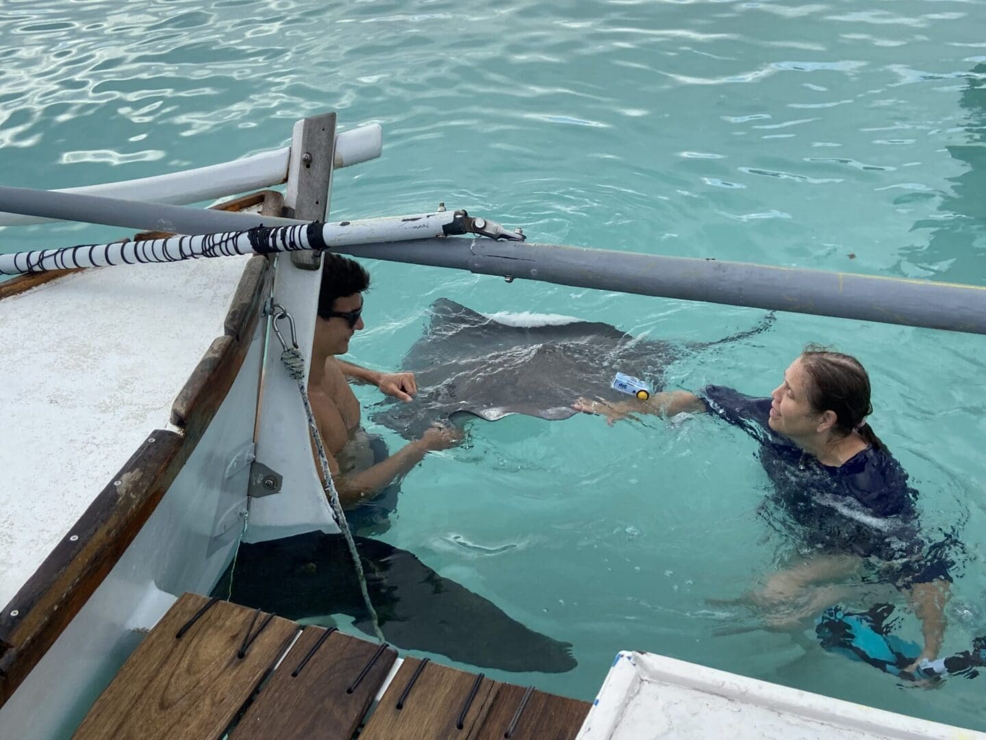 Two people in a boat with an animal.